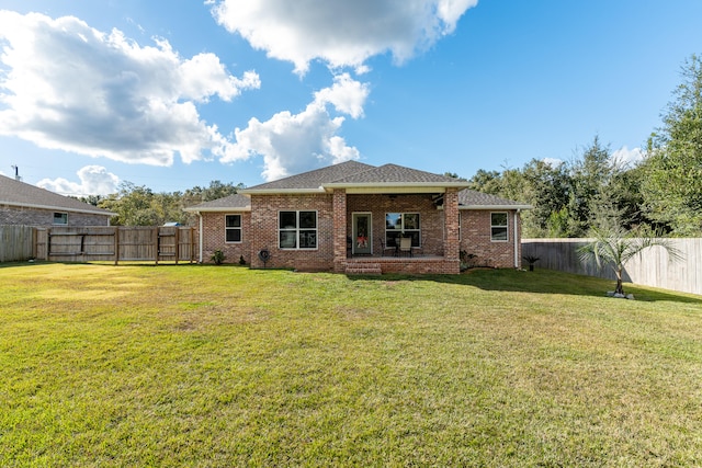 back of house with a yard