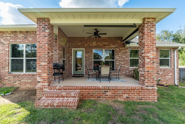 exterior space with ceiling fan