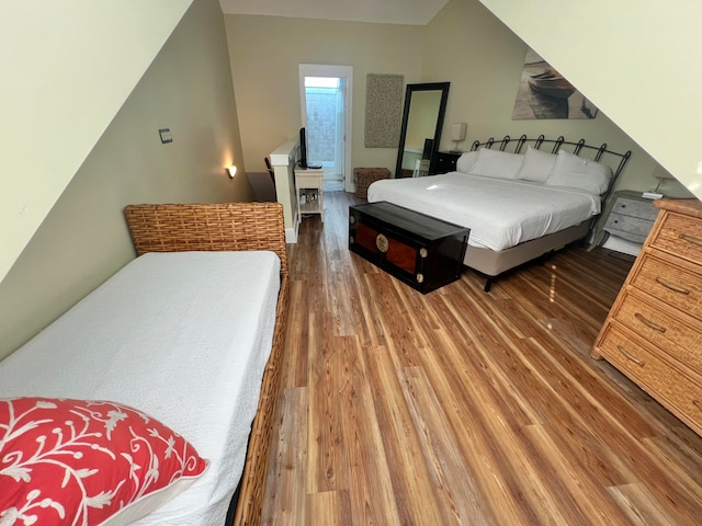 bedroom with dark hardwood / wood-style floors