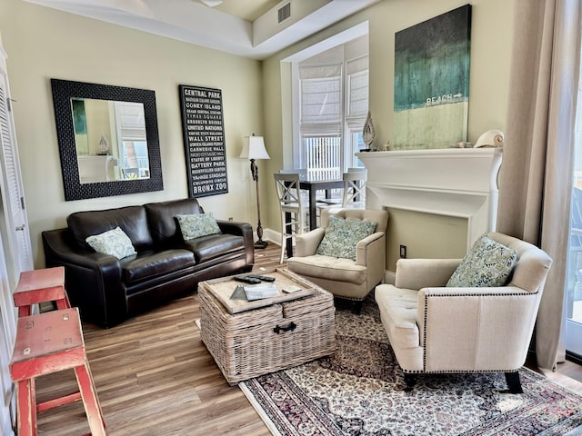 sitting room with wood-type flooring