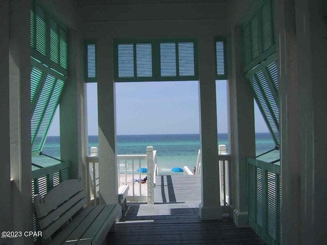 doorway to outside with wood-type flooring and a water view