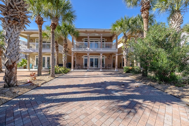 view of front of house with a balcony and french doors