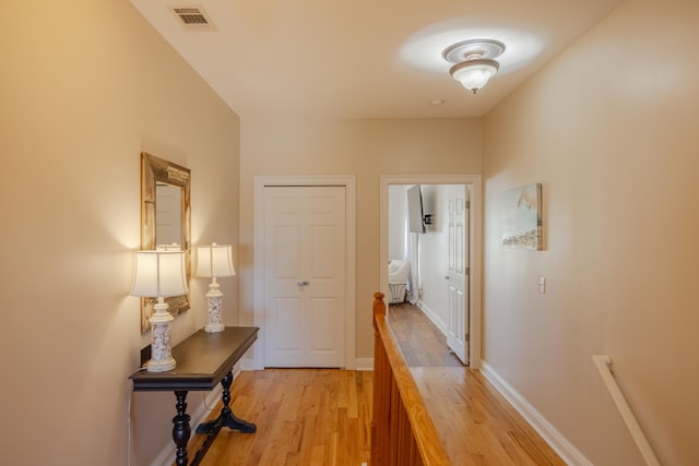 hallway with light hardwood / wood-style flooring