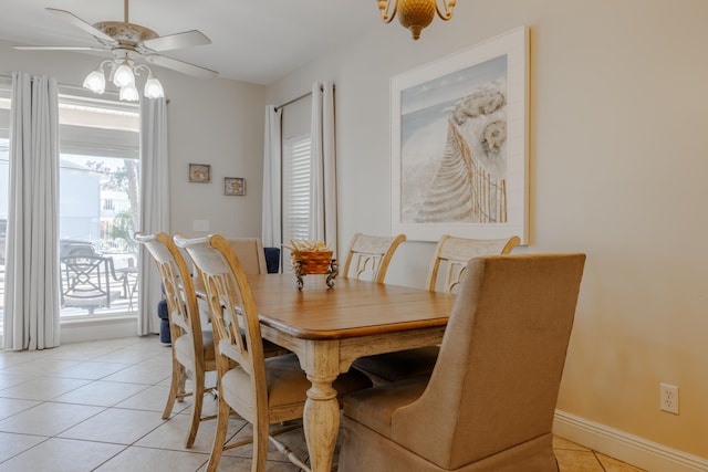 tiled dining space with ceiling fan