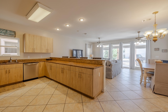 kitchen with dishwasher, light brown cabinets, and sink