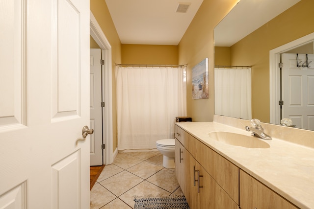 bathroom with tile patterned floors, vanity, and toilet