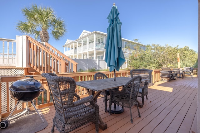 wooden deck with a water view and area for grilling