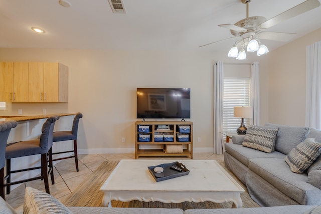 tiled living room with ceiling fan