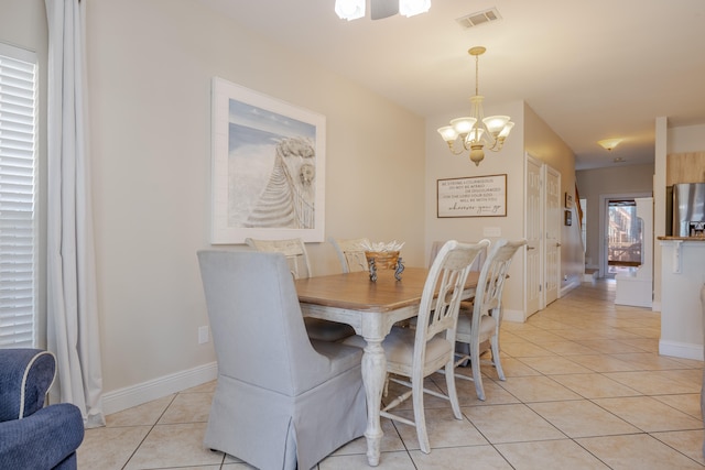 tiled dining space with an inviting chandelier