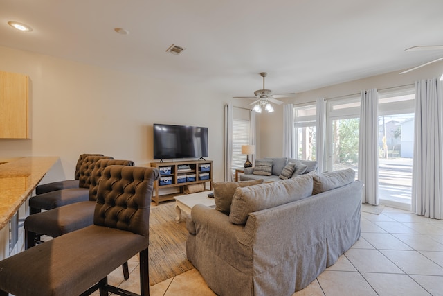 tiled living room with ceiling fan