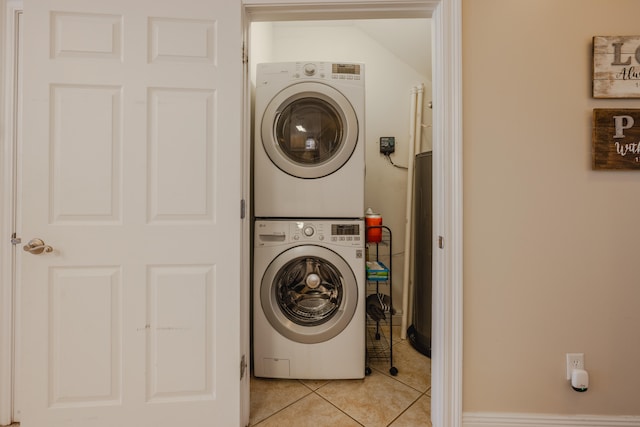 washroom with light tile patterned floors and stacked washer and clothes dryer