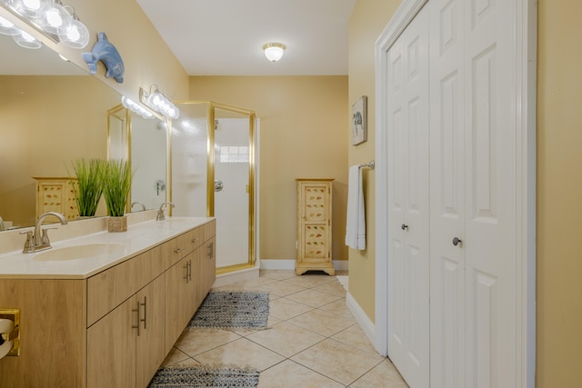 bathroom featuring tile patterned floors, vanity, and a shower with shower door