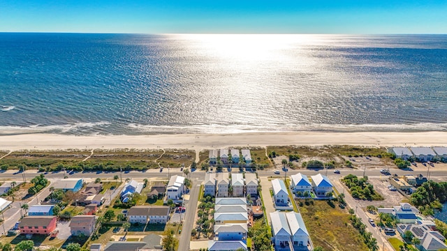 birds eye view of property with a water view and a view of the beach