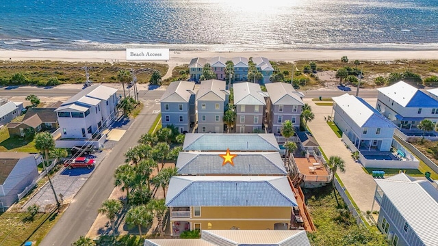 bird's eye view featuring a water view and a beach view