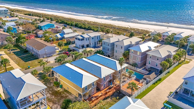 drone / aerial view featuring a water view and a view of the beach