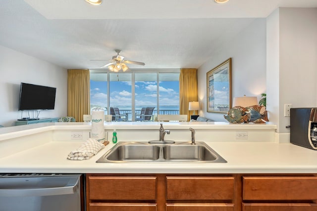 kitchen featuring stainless steel dishwasher, ceiling fan, and sink