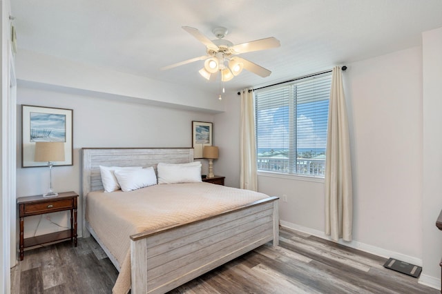 bedroom with ceiling fan and hardwood / wood-style floors