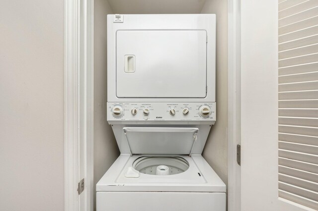 laundry area featuring stacked washing maching and dryer