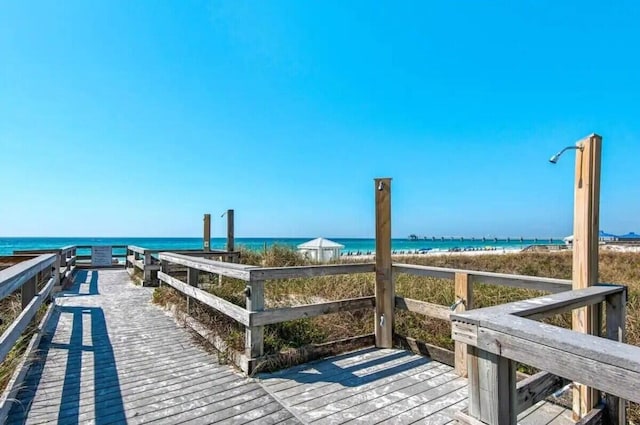 exterior space featuring a water view and a beach view