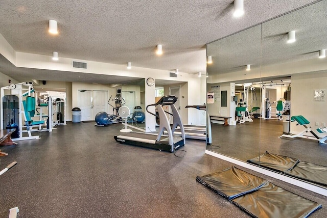 gym with a textured ceiling