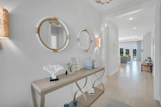 hallway featuring french doors and light hardwood / wood-style flooring