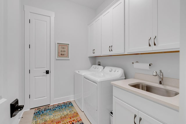 laundry room with cabinets, separate washer and dryer, sink, and light tile patterned floors