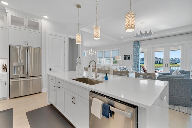 kitchen with a healthy amount of sunlight, sink, white cabinetry, and stainless steel appliances