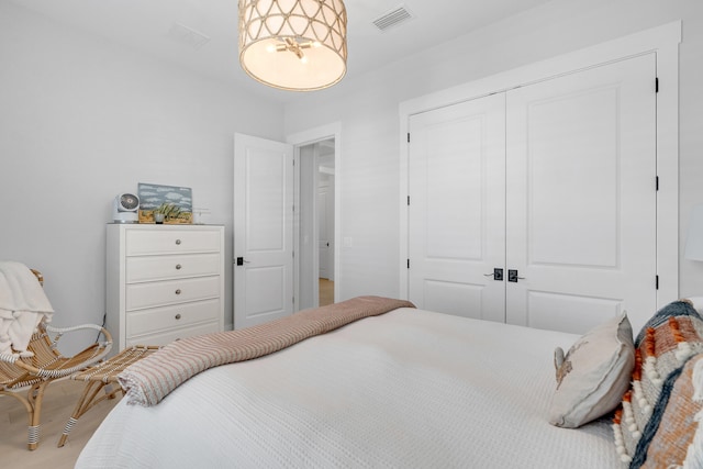 bedroom featuring hardwood / wood-style floors and a closet