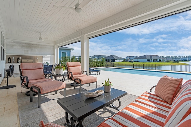 view of patio / terrace with a fenced in pool and ceiling fan