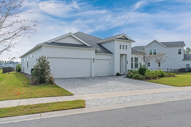 view of front facade with a front yard and a garage