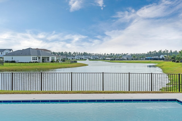 view of swimming pool with a water view