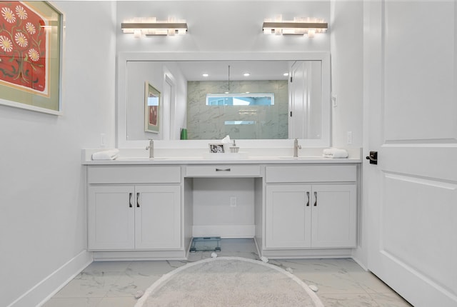 bathroom with a tile shower and vanity