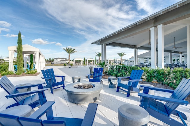 view of patio featuring an outdoor fire pit and ceiling fan