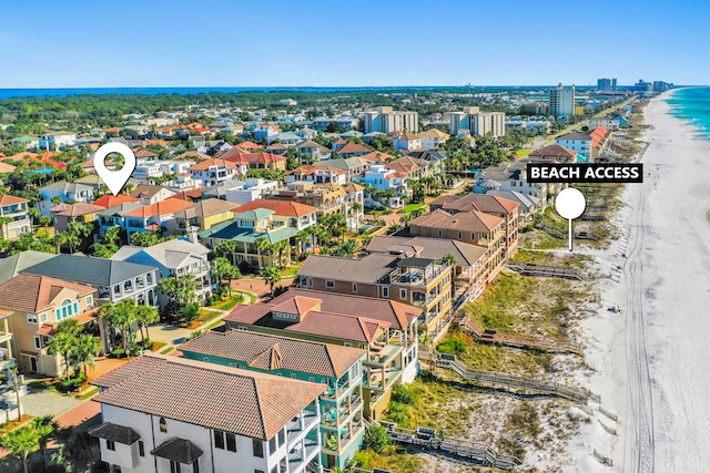 drone / aerial view featuring a water view and a beach view