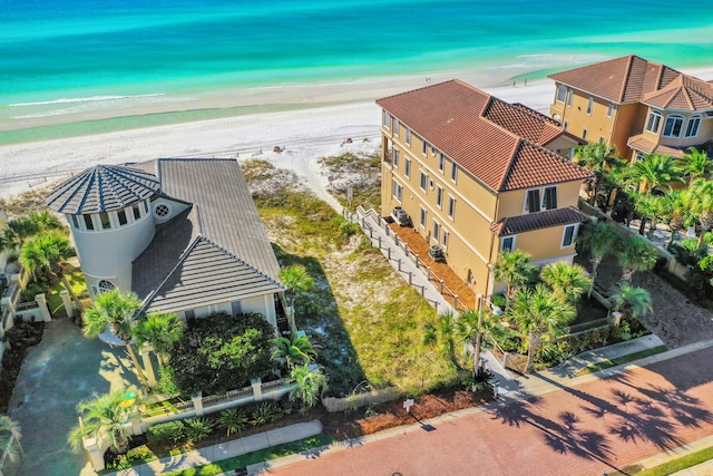 drone / aerial view with a beach view and a water view