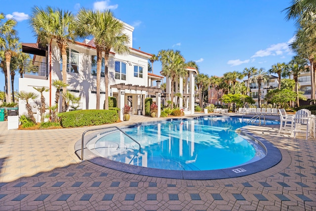 view of swimming pool with a patio area and a pergola