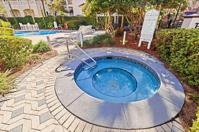 view of swimming pool with a community hot tub