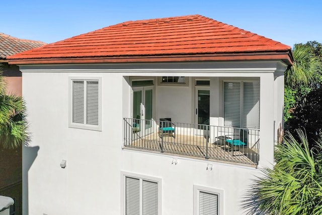 back of house featuring french doors and a balcony