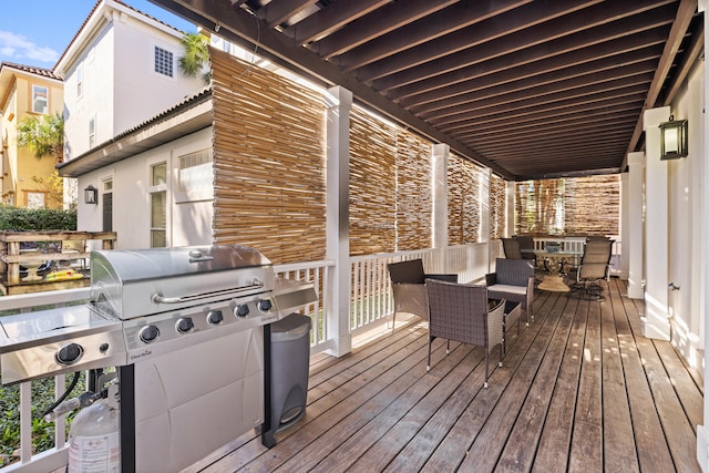 wooden terrace featuring a grill