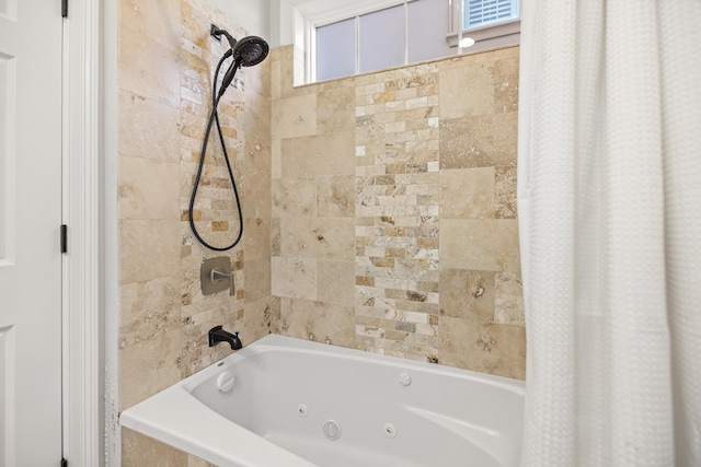 bathroom with plenty of natural light and shower / tub combo