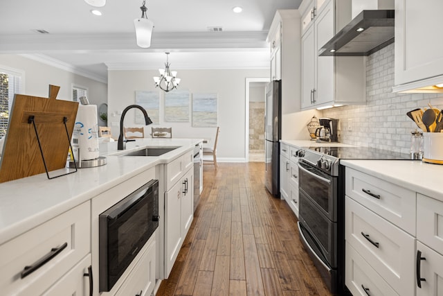 kitchen with sink, stainless steel appliances, wall chimney range hood, dark hardwood / wood-style flooring, and white cabinets