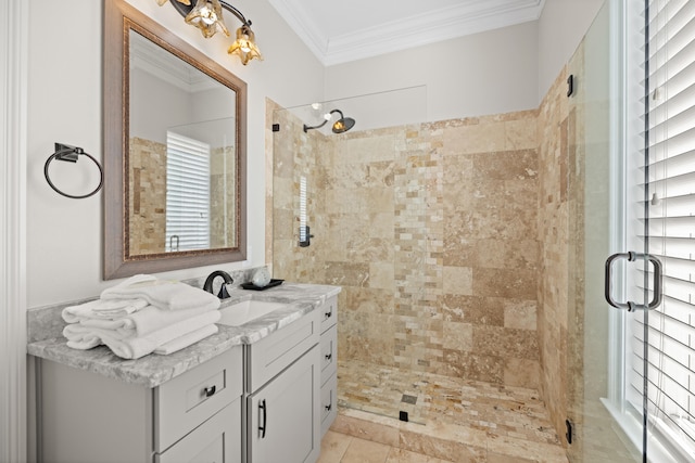 bathroom featuring vanity, a shower with shower door, and ornamental molding