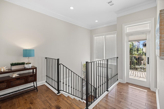 staircase featuring hardwood / wood-style flooring and crown molding