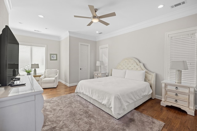 bedroom with dark hardwood / wood-style floors, ceiling fan, and crown molding