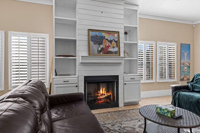 living room featuring built in shelves, light tile patterned floors, and a wealth of natural light