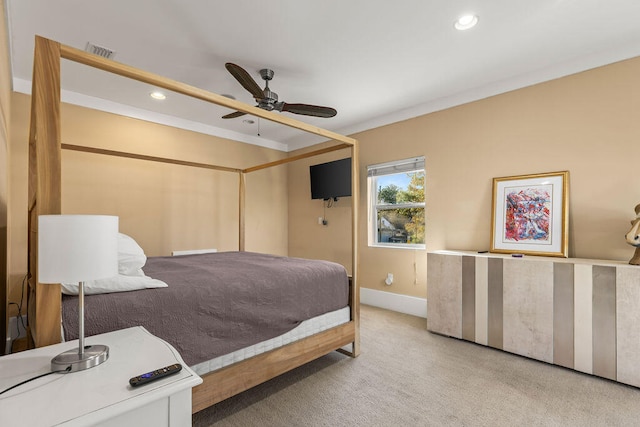 carpeted bedroom with ceiling fan and crown molding