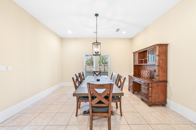 tiled dining area featuring an inviting chandelier