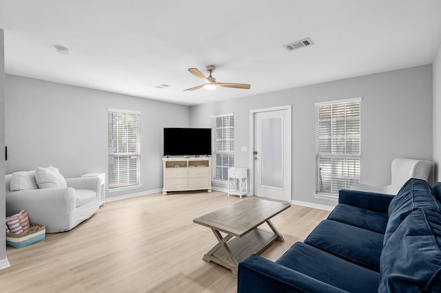 living room featuring ceiling fan and hardwood / wood-style floors