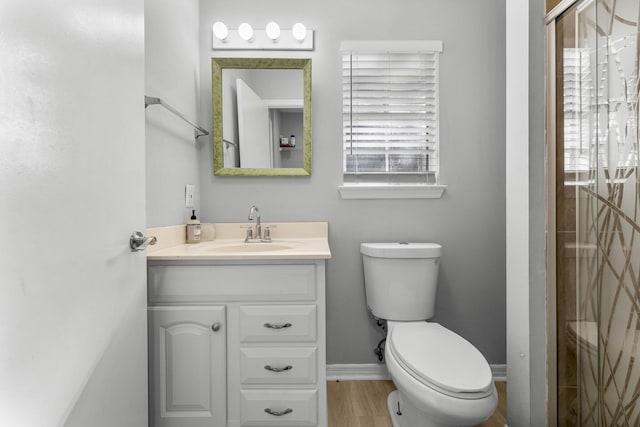 bathroom with vanity, toilet, wood-type flooring, and walk in shower