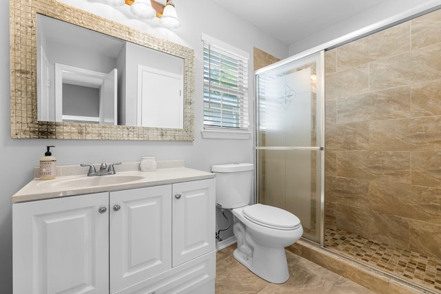 bathroom with vanity, an enclosed shower, and toilet